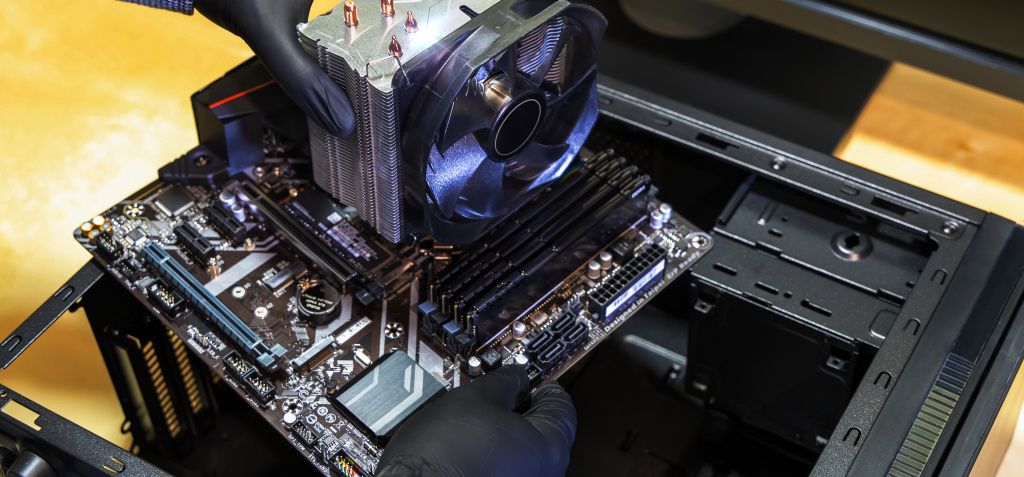 Person mounting motherboard into PC case
